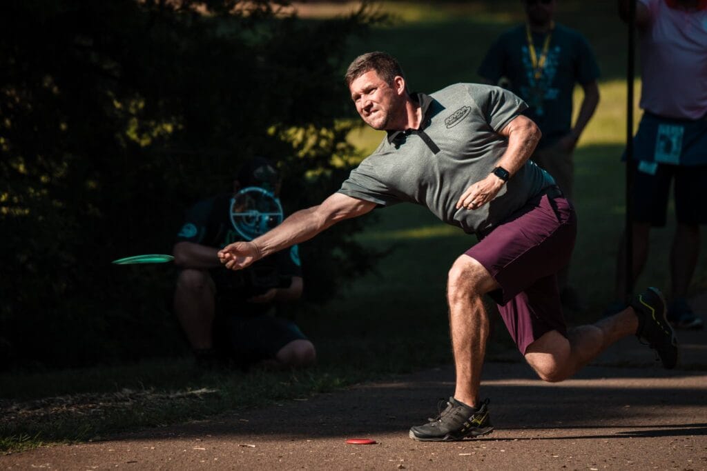 Innova Team member Nate Sexton throws a driver behind a mini marker.