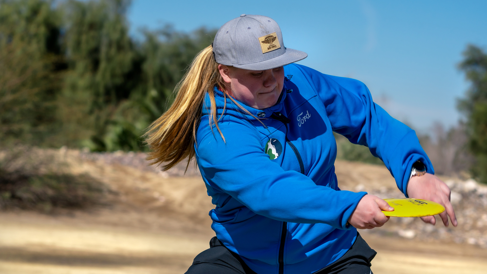 Innova Team member Evelina Salonen demonstrating a backhand drive, one of the key disc golf terms.