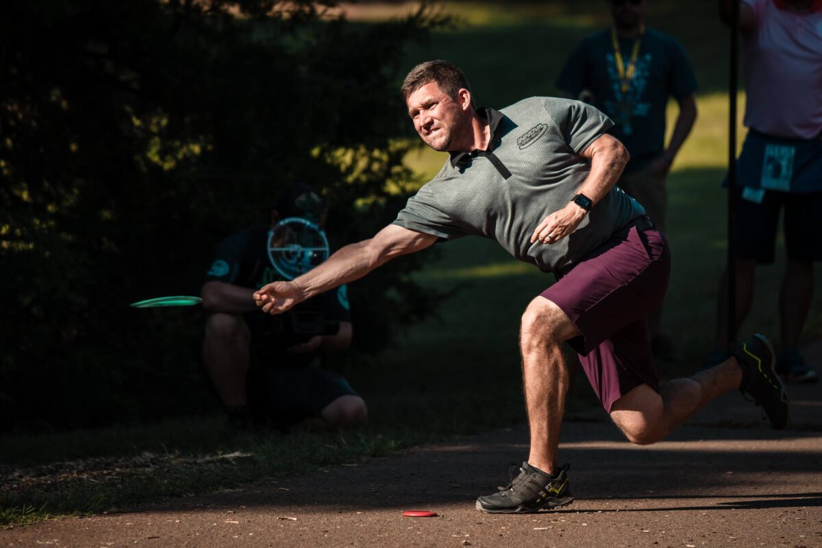 Disc golfer using mini disc to throw shot from