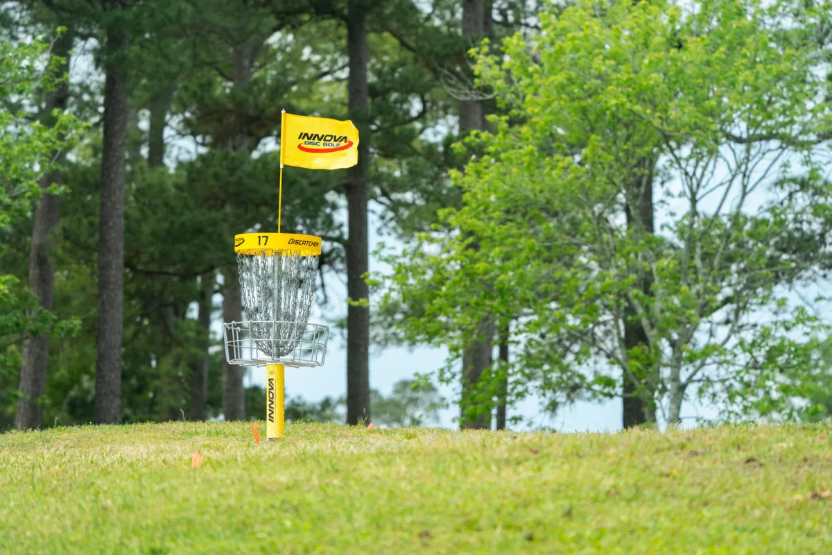 What is disc golf? Disc golf uses baskets with disc catching chains to complete the hole.