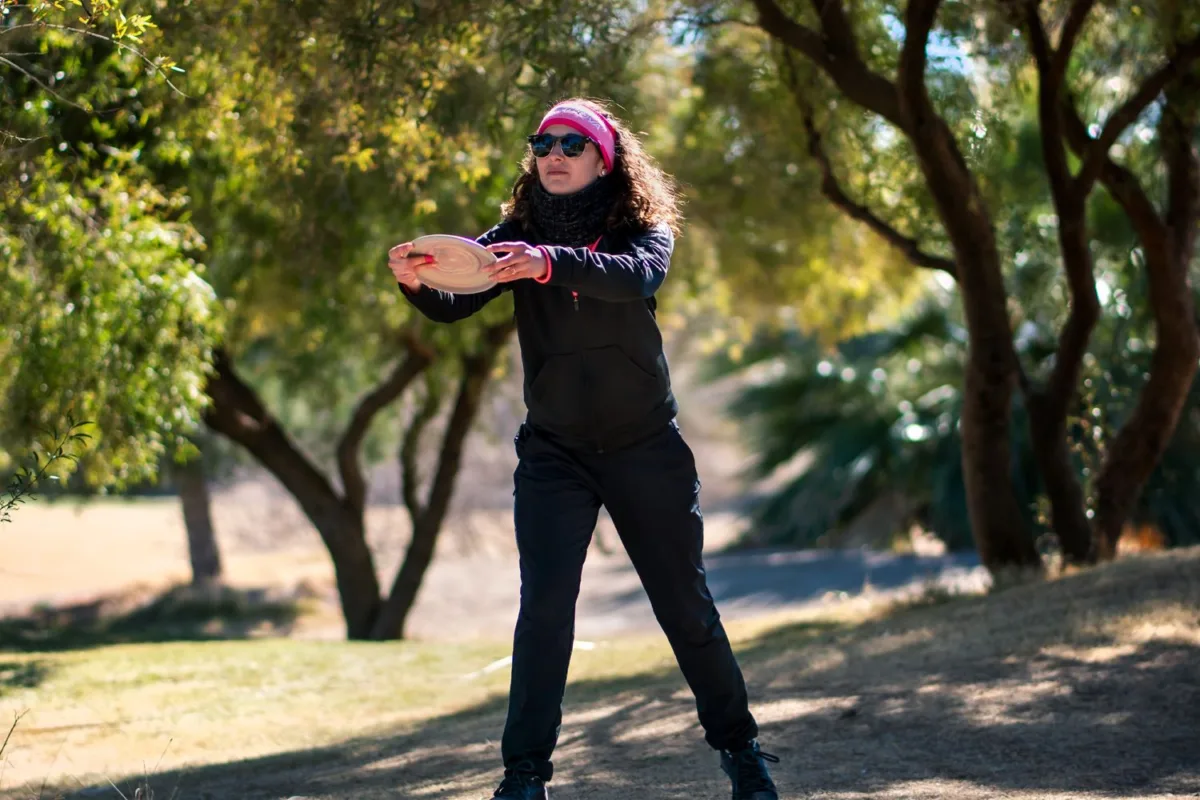 Disc golf putting. Jessica Weese lines up for a putt during a round. 