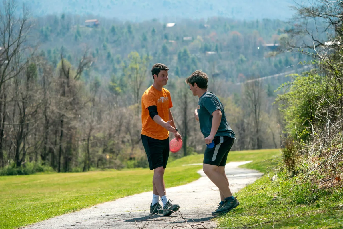 Variations of disc golf: Disc golfers from a team event celebrate. 