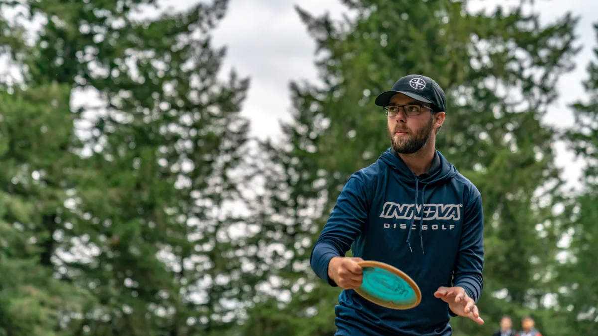 Professional disc golfer Bradley Williams shows off a long sleeve shirt used for cooler weather.